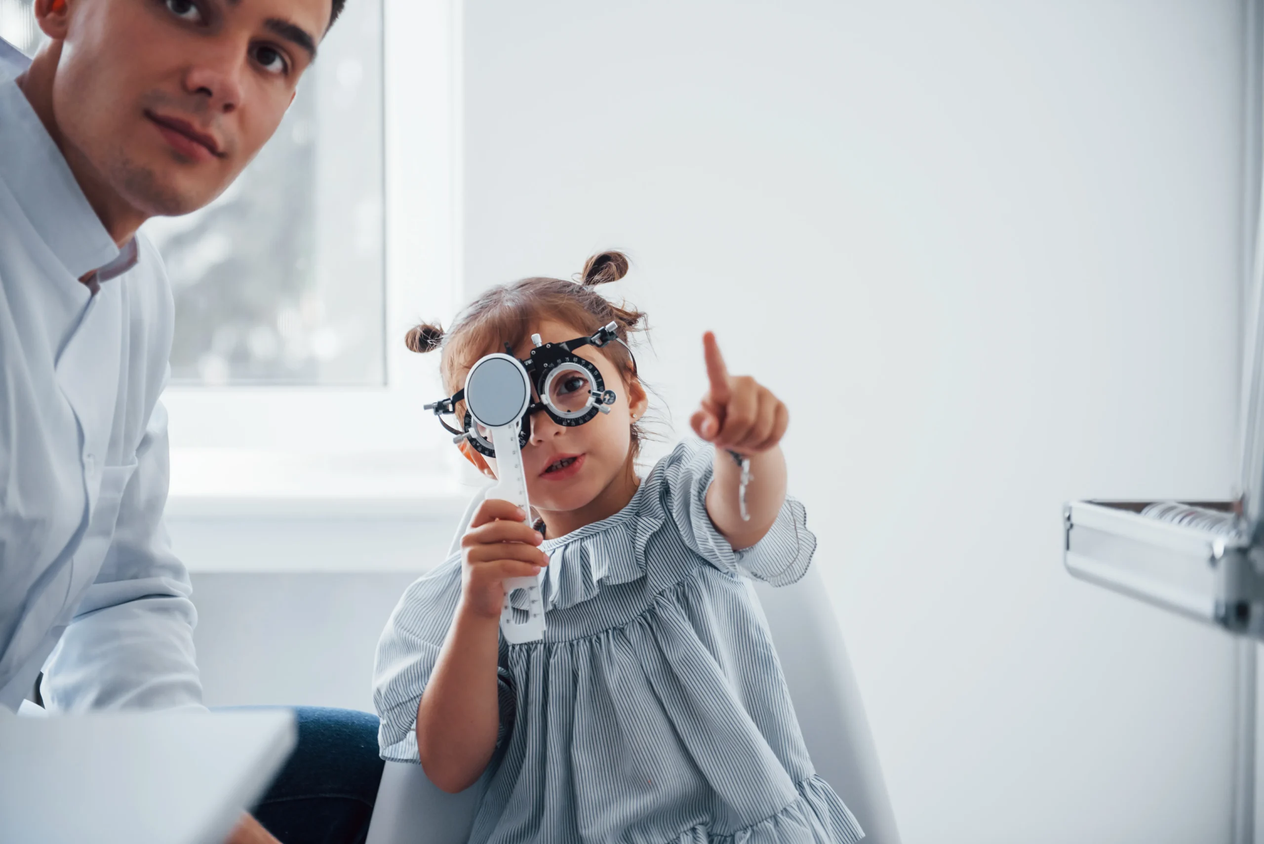 testing-vision-young-ophthalmologist-is-with-little-female-visitor-clinic